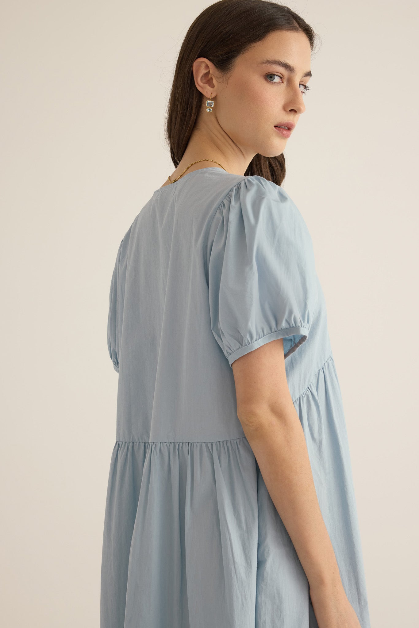 Close up side detail of the Amelie organic cotton v-lace midi dress in forget me not pale blue, showing puff sleeve.