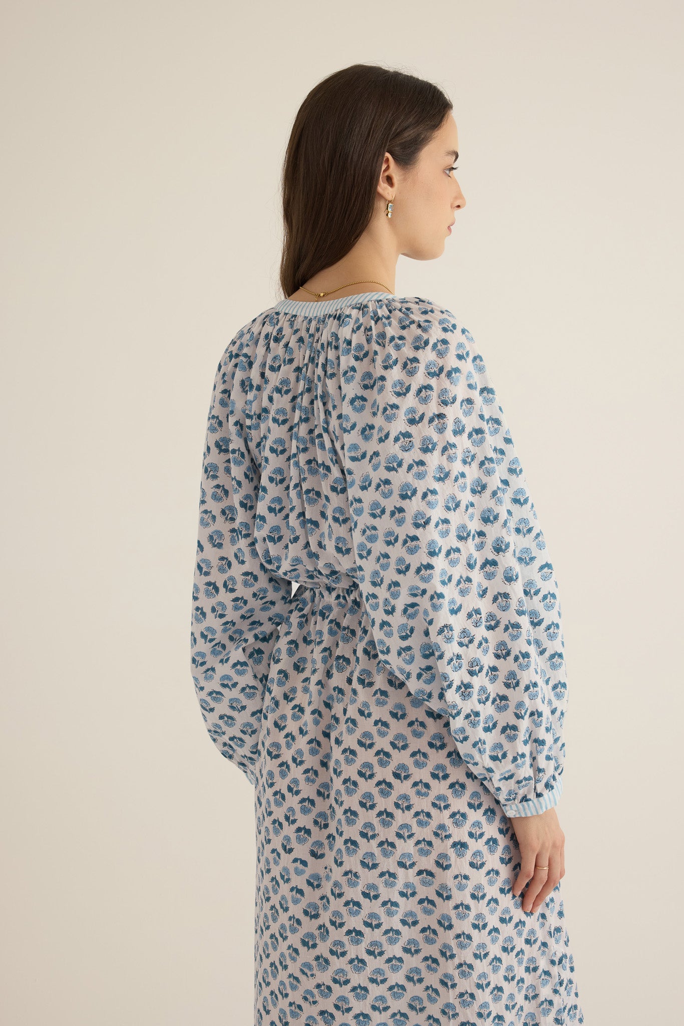 Side closeup view of model wearing the Juliet Block Printed Cotton Drop Sleeve Raglan Shirt Dress in Blue Gardenia, showing the billowing sleeve and gathered detail
