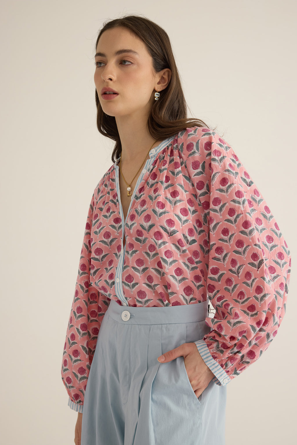 Side view of model wearing the Juliet Block Printed Cotton Drop Sleeve Raglan Shirt in Pink Dahlia, with hand in pocket