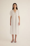Front view of model wearing the Amelie organic cotton v-lace midi dress in ivory