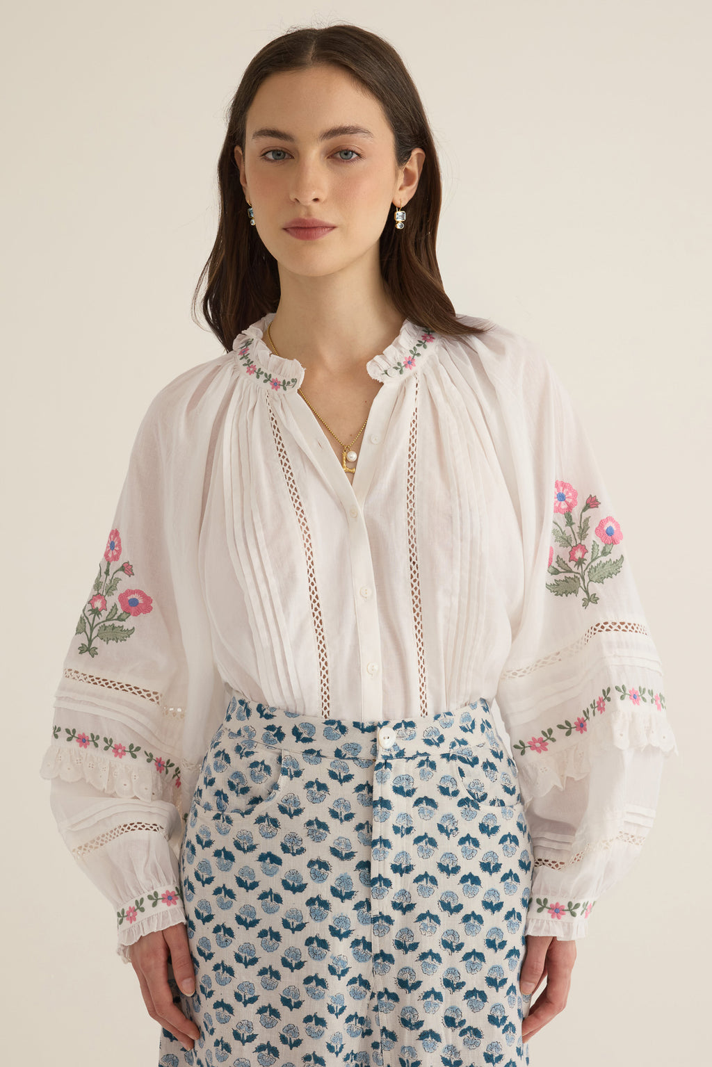 Front view of model wearing the Juliet Embroidered Cotton Juliet Drop Sleeve Raglan Shirt in Ivory with floral embroidered motifs, pintucking and lace detail