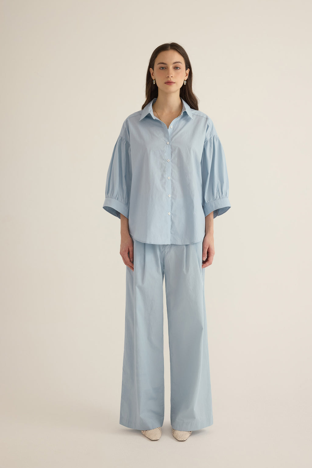 Close up of model wearing the Romeo wide cuff shirt and pleated pant in forget me not pale blue