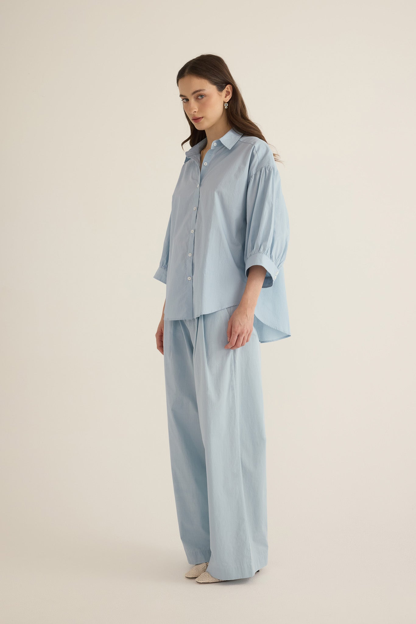 Model wearing the Romeo wide cuff shirt and pleated pant in forget me not pale blue