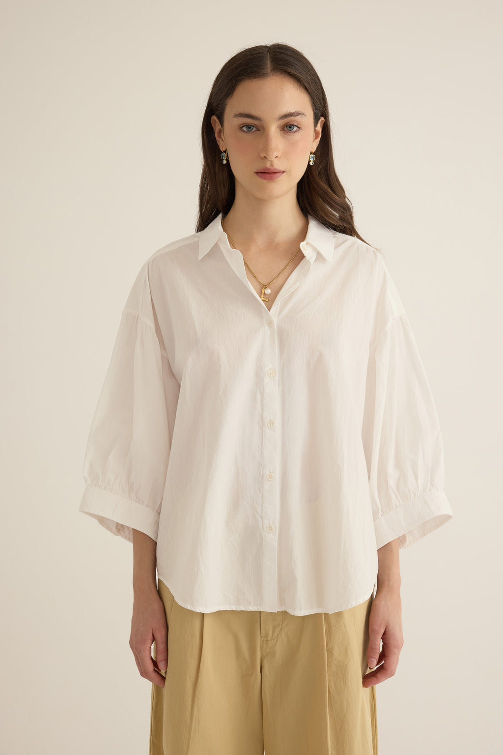 Model wearing the Romeo wide cuff shirt in ivory organic cotton, styled with the Romeo wide leg pleat pant in taos taupe beige