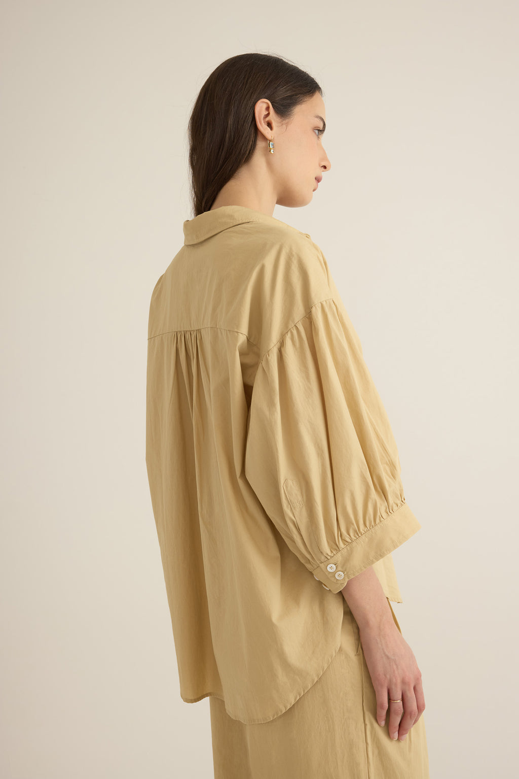 Side view of model wearing the Romeo wide cuff shirt in taos taupe beige