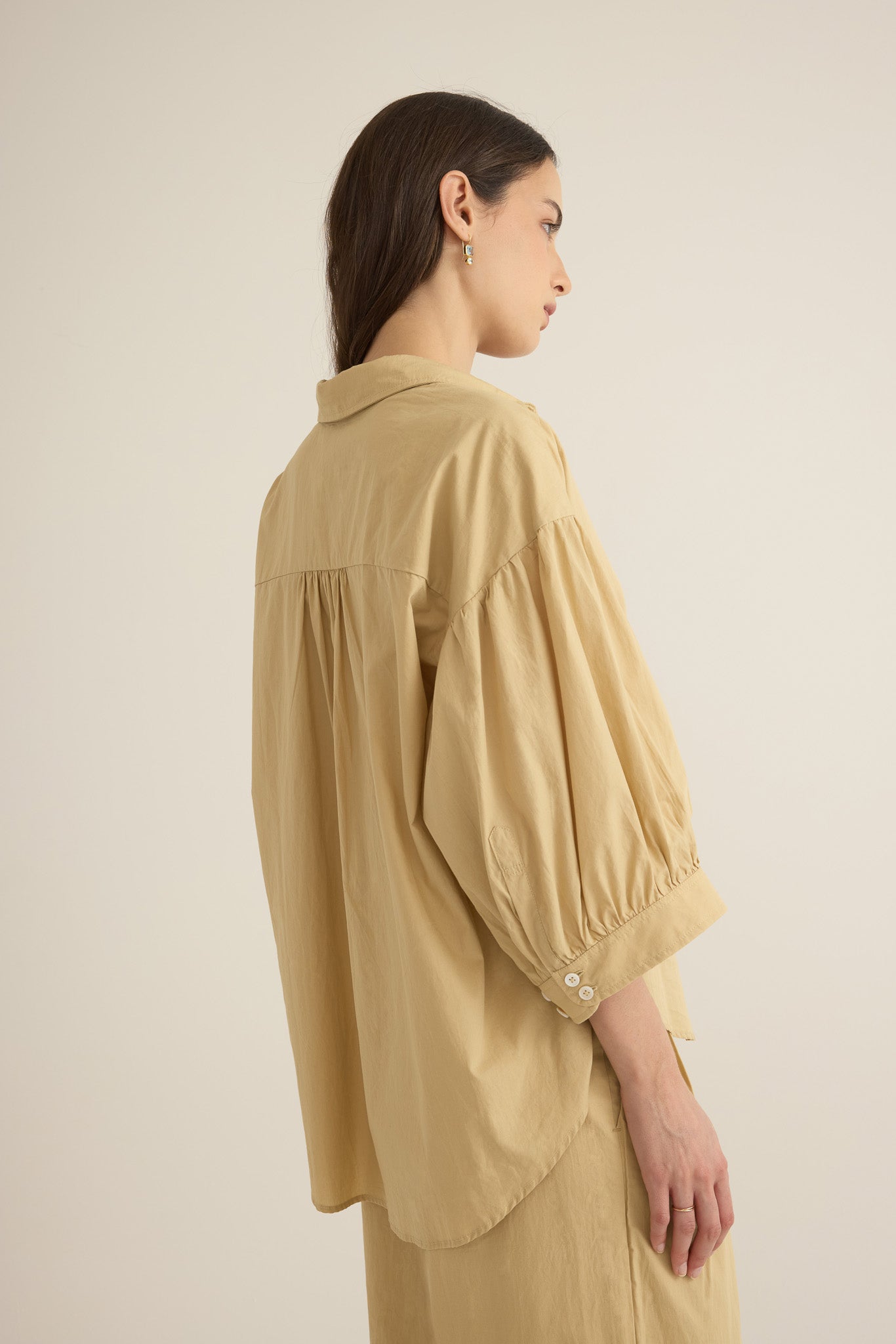 Side view of model wearing the Romeo wide cuff shirt in taos taupe beige