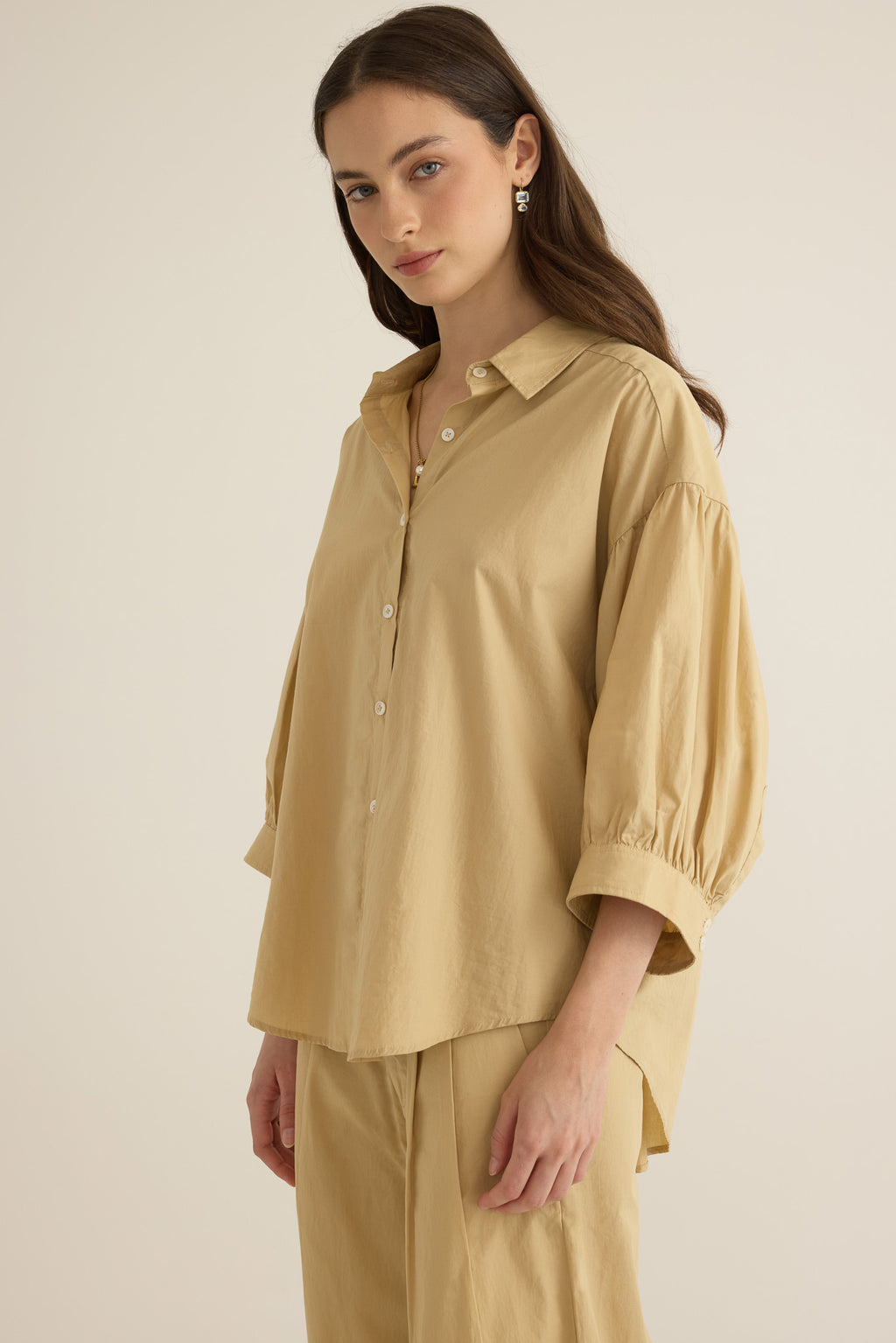Close up of model wearing the Romeo wide cuff shirt in taos taupe beige